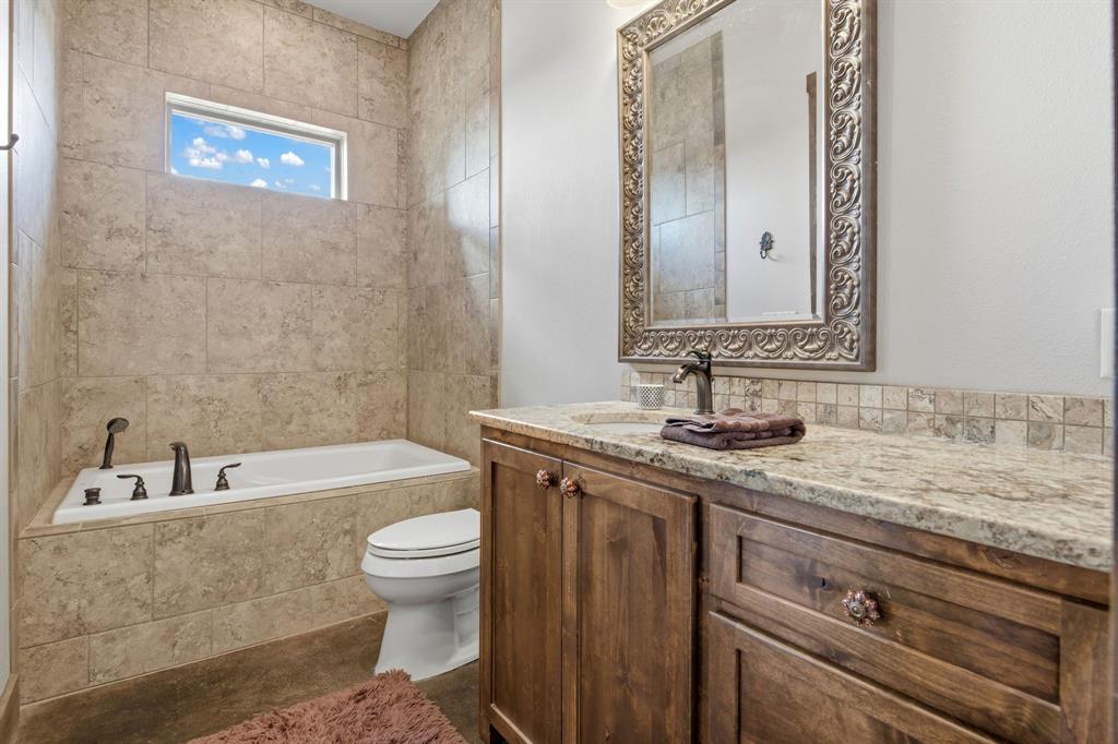 650 Fm 2035 Merkel, TX 79536 - Photo 33 of 40 a bathroom with a granite countertop sink a toilet and a bathtub