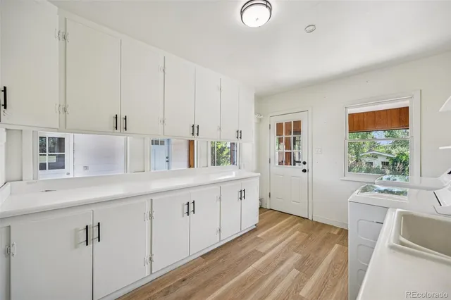 a kitchen with sink and cabinets