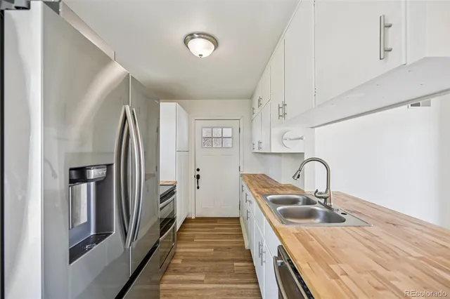 a kitchen with a refrigerator and a sink