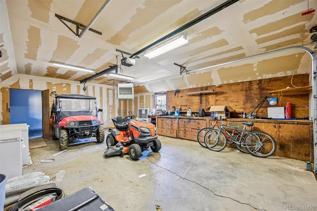 a view of a garage with a bike and a car