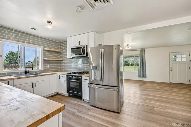 a kitchen with wooden cabinets and stainless steel appliances