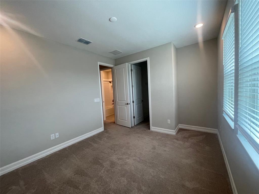 4596 Almada Lane Wesley Chapel, FL 33543 - Photo 12 of 56 an empty room with windows