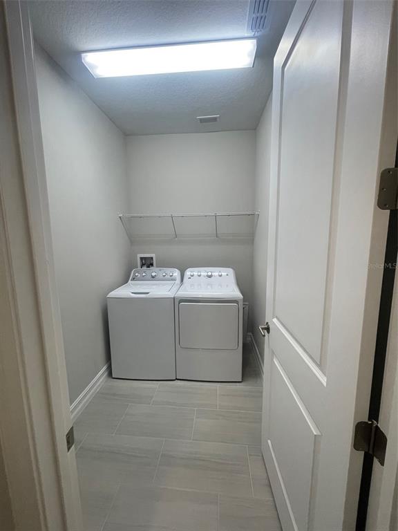 4596 Almada Lane Wesley Chapel, FL 33543 - Photo 13 of 56 a utility room with dryer and washer