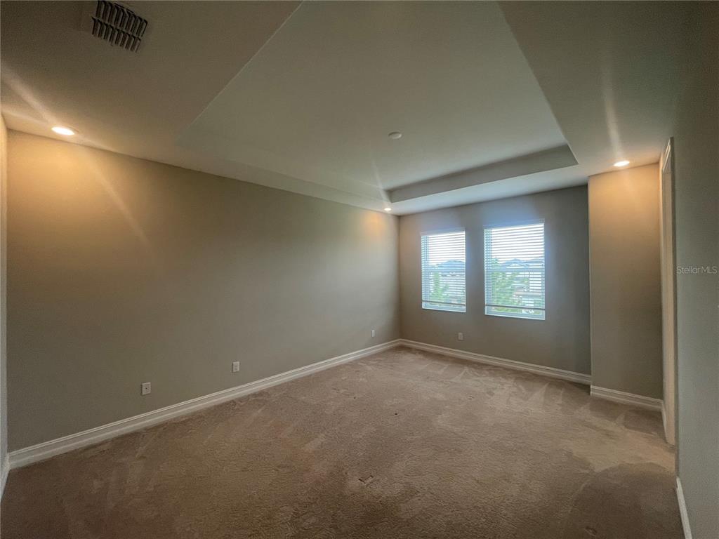 4596 Almada Lane Wesley Chapel, FL 33543 - Photo 14 of 56 a view of an empty room with a window