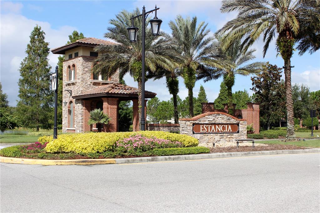 4596 Almada Lane Wesley Chapel, FL 33543 - Photo 17 of 56 a front view of a house with garden and parking
