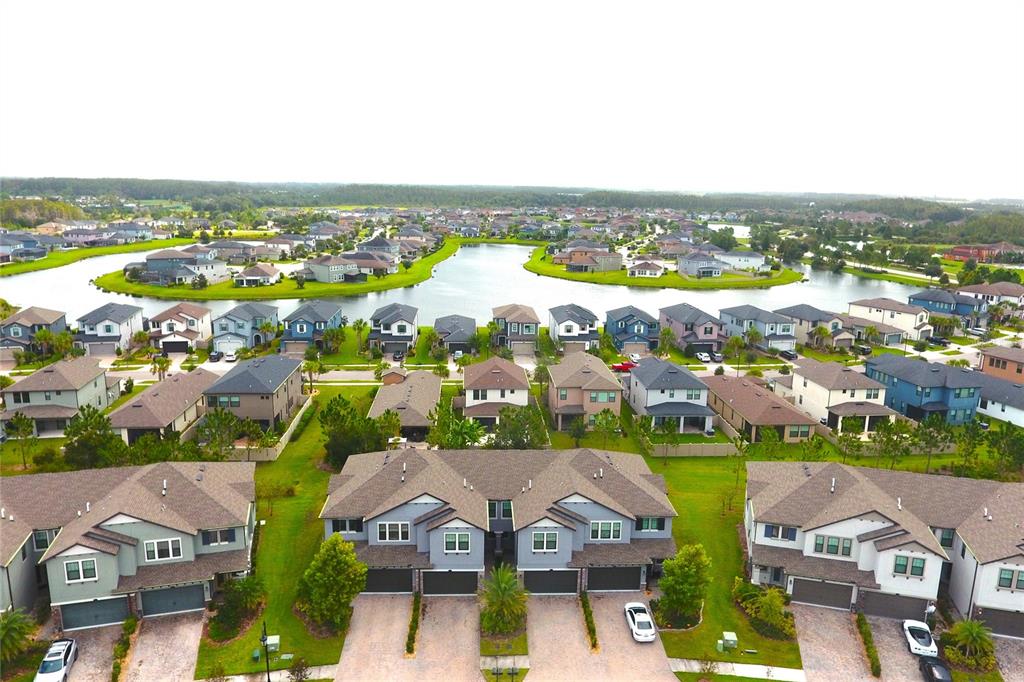 4596 Almada Lane Wesley Chapel, FL 33543 - Photo 22 of 56 an aerial view of residential houses with city view