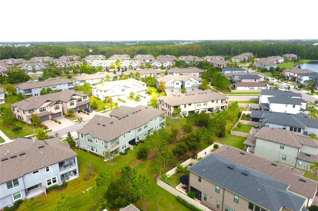 4596 Almada Lane Wesley Chapel, FL 33543 - Photo 30 of 56 an aerial view of residential houses with outdoor space
