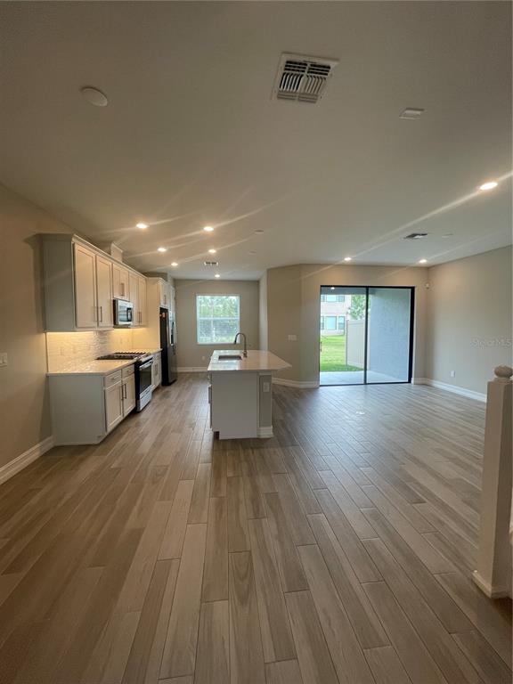 4596 Almada Lane Wesley Chapel, FL 33543 - Photo 3 of 56 a large living room with a large window