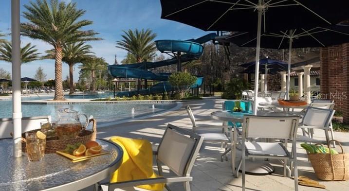 4596 Almada Lane Wesley Chapel, FL 33543 - Photo 40 of 56 a swimming pool with outdoor seating and yard