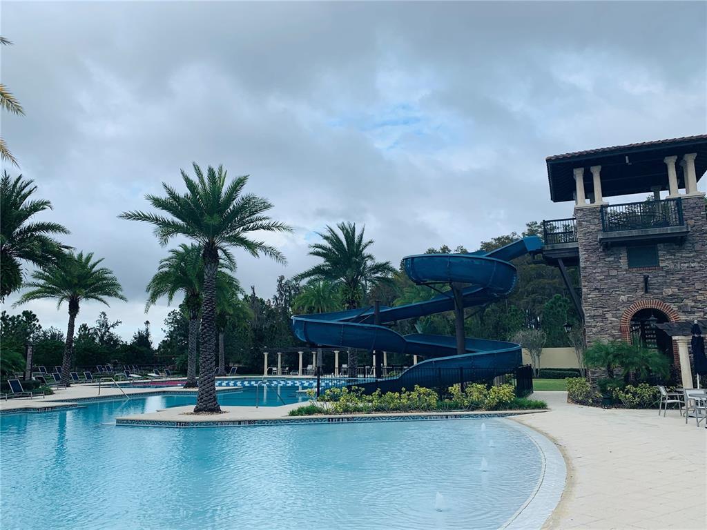 4596 Almada Lane Wesley Chapel, FL 33543 - Photo 44 of 56 a view of a swimming pool with a patio and a lake view