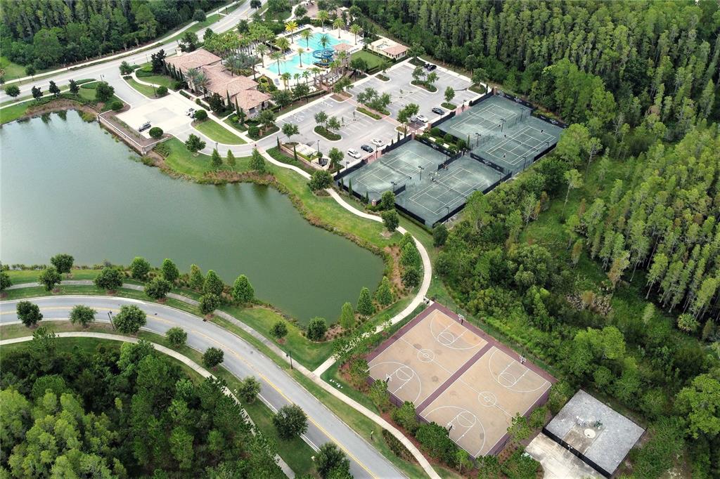 4596 Almada Lane Wesley Chapel, FL 33543 - Photo 55 of 56 an aerial view of a house with a yard and lake view