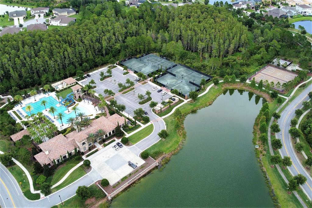 4596 Almada Lane Wesley Chapel, FL 33543 - Photo 56 of 56 an aerial view of a house with a yard and lake view