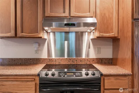 a stove top oven sitting inside of a kitchen