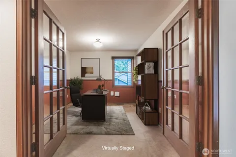 a living room with wooden floor and furniture