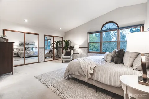 a bedroom with a bed and a large window