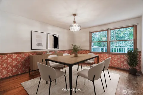 a view of a dining room with furniture window and wooden floor