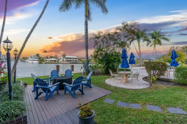 a view of a backyard with sitting area and garden