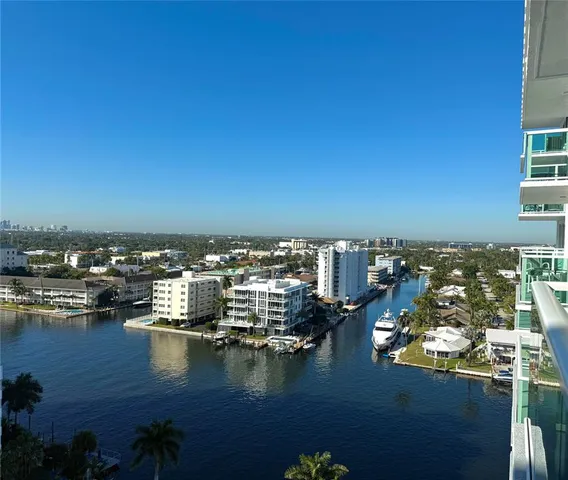a view of a ocean with boats and trees in the background