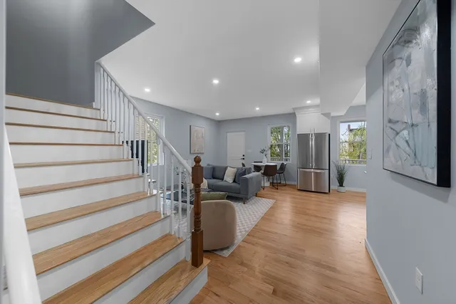 a view of a hallway with wooden floor