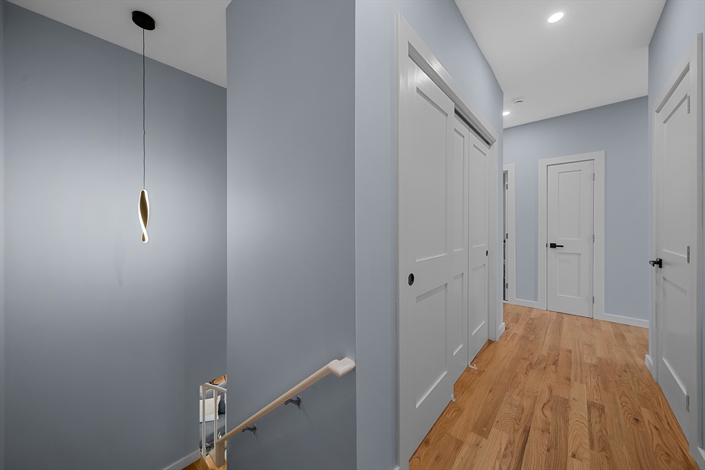 175 Howard Avenue, Unit 2 Boston, MA 02125 - Photo 12 of 26 a view of a hallway with wooden floor