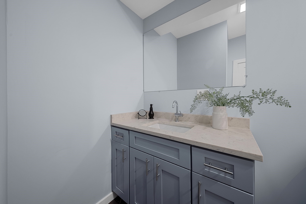 175 Howard Avenue, Unit 2 Boston, MA 02125 - Photo 15 of 26 a bathroom with a granite countertop sink and a mirror