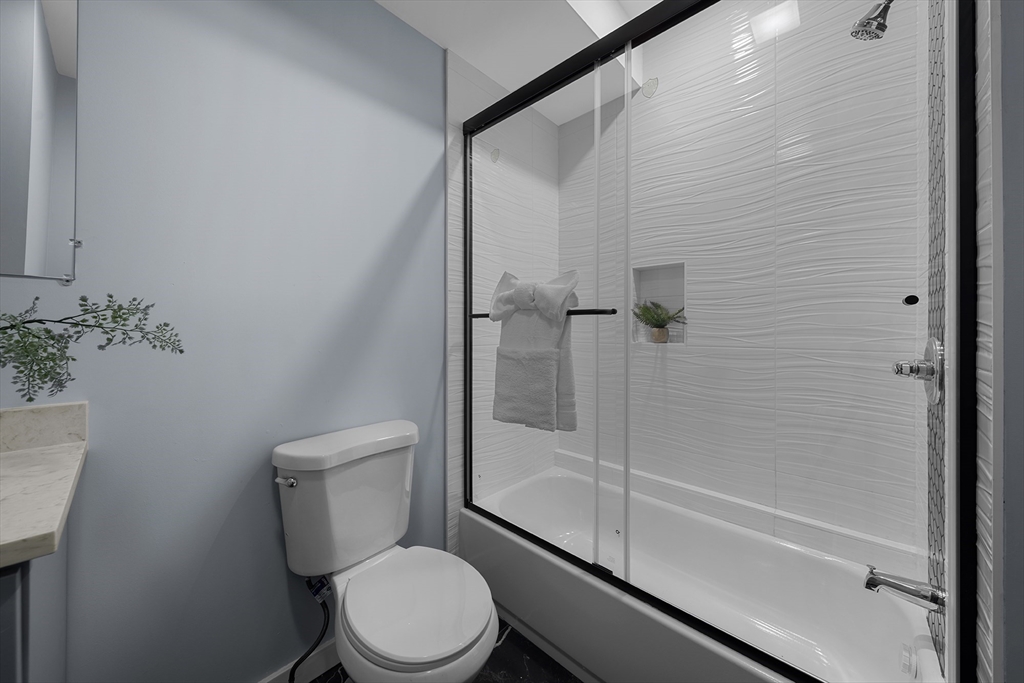 175 Howard Avenue, Unit 2 Boston, MA 02125 - Photo 16 of 26 a white toilet sitting next to a bath tub