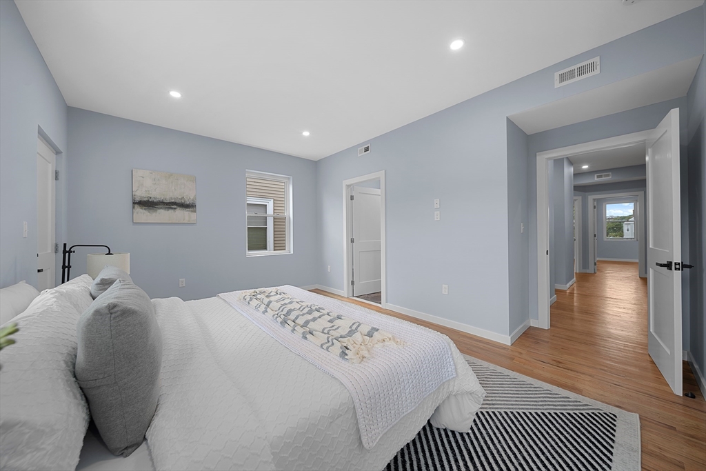 175 Howard Avenue, Unit 2 Boston, MA 02125 - Photo 21 of 26 a bedroom with a large bed rug and a window