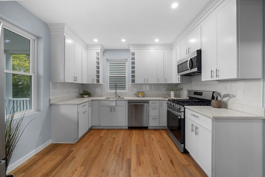 175 Howard Avenue, Unit 2 Boston, MA 02125 - Photo 6 of 26 a kitchen with stainless steel appliances granite countertop a sink a stove a refrigerator and cabinets