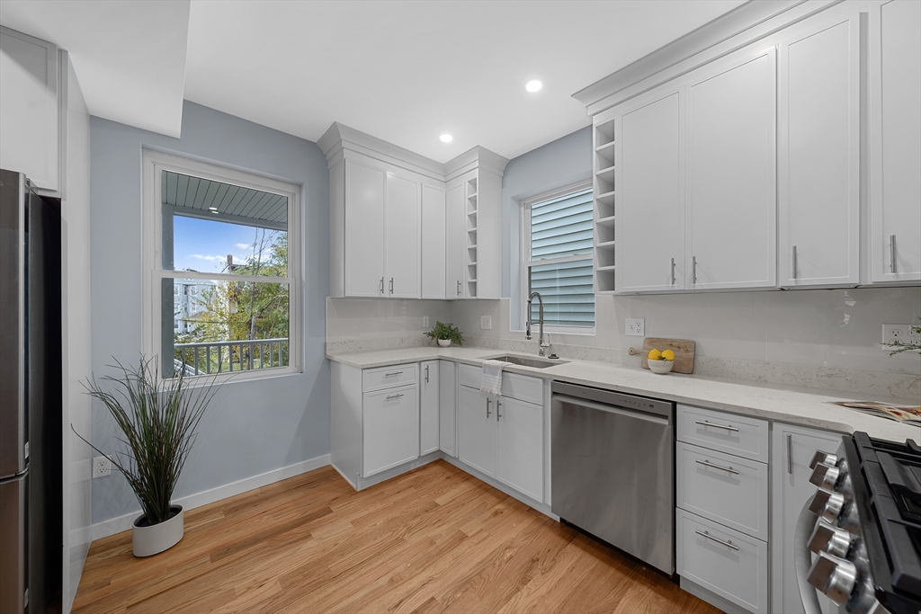175 Howard Avenue, Unit 2 Boston, MA 02125 - Photo 8 of 26 a kitchen with granite countertop white cabinets and white appliances
