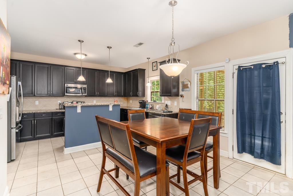 40 Cromwell Circle Cameron, NC 28326 - Photo 13 of 23 a kitchen with stainless steel appliances granite countertop a stove top oven a sink a dining table and chairs
