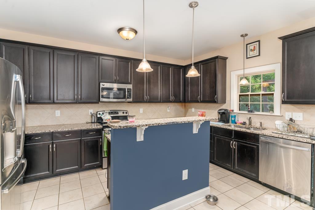 40 Cromwell Circle Cameron, NC 28326 - Photo 15 of 23 a kitchen with a sink and wooden cabinets