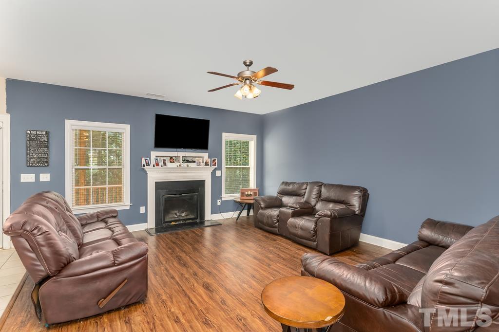 40 Cromwell Circle Cameron, NC 28326 - Photo 10 of 23 a living room with furniture a fireplace and a flat screen tv