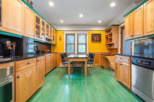 a kitchen with stainless steel appliances granite countertop a refrigerator and window