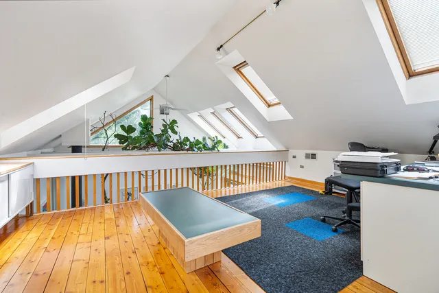 a living room with wooden floor and furniture