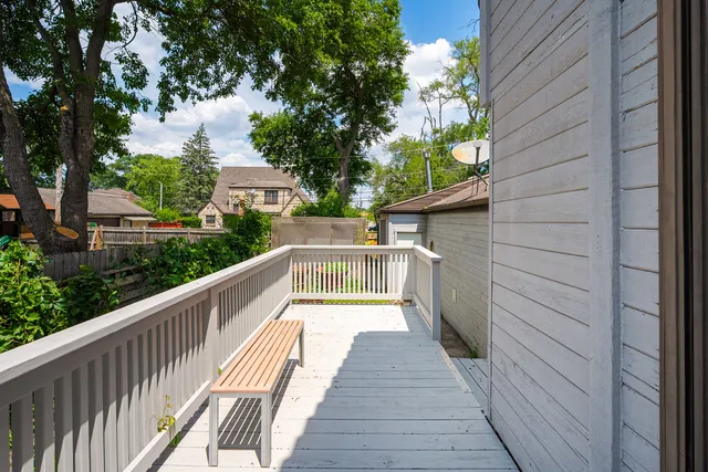a view of a patio with table and chairs and wooden floor