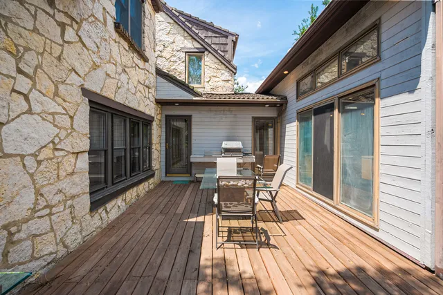 a backyard of a house with table and chairs
