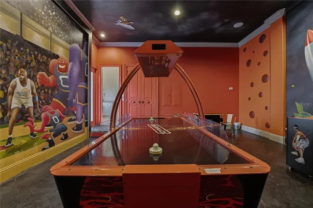 a bedroom with a large bed and a chandelier