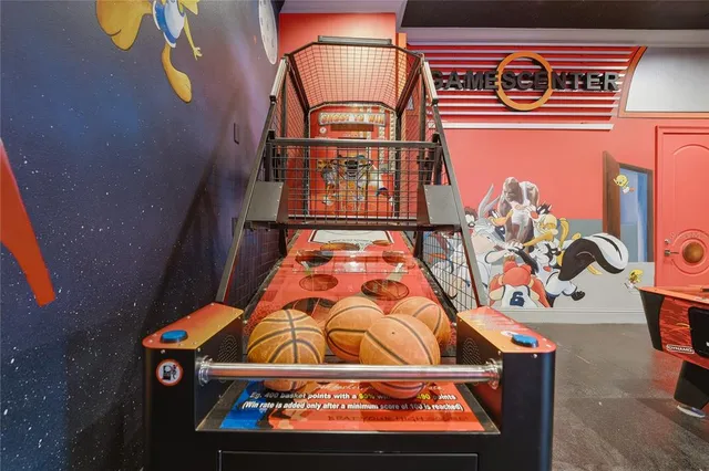 a bedroom with a large bed and a chandelier