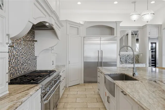 a view of a dining room with furniture a chandelier and wooden floor