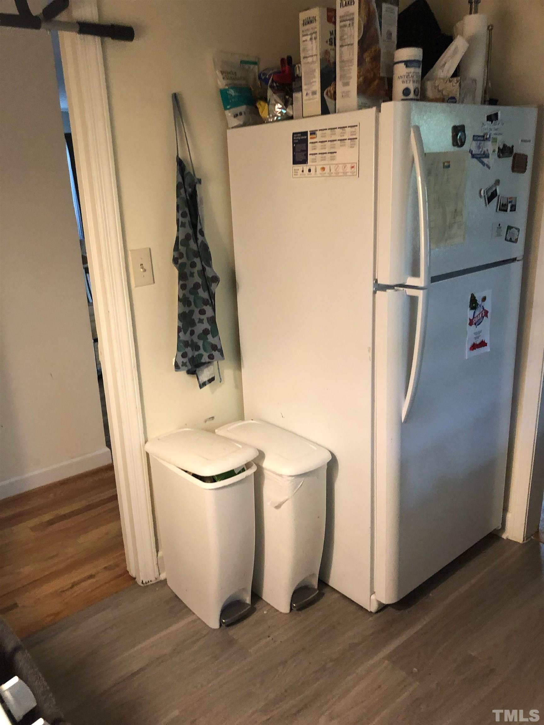 822-824 Chamberlain Street Raleigh, NC 27607 - Photo 6 of 8 a view of a refrigerator with wooden floor