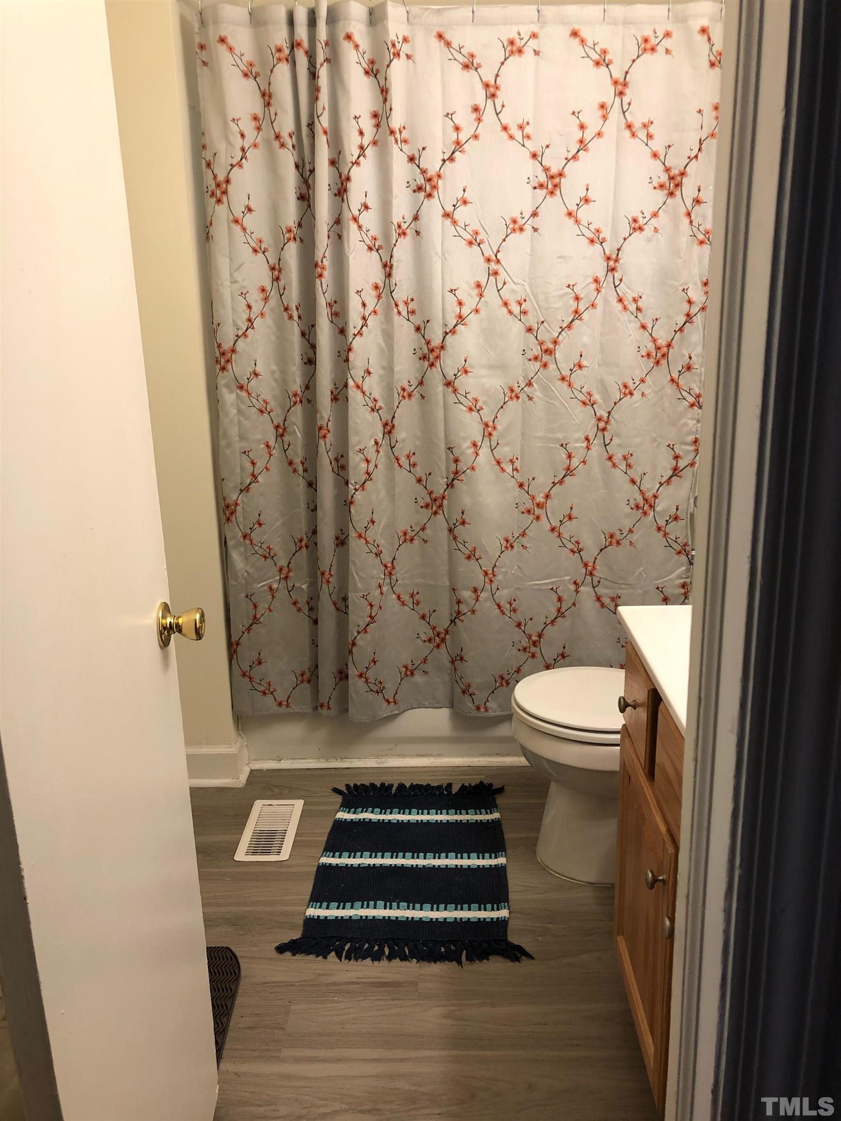 822-824 Chamberlain Street Raleigh, NC 27607 - Photo 8 of 8 a bathroom with a toilet and a shower curtain