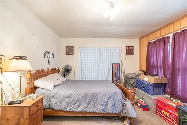 a bedroom with bed and a dresser