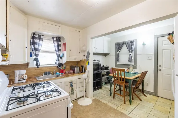 a kitchen with stainless steel appliances kitchen island granite countertop a stove and a refrigerator