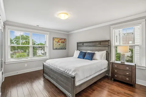 a bedroom with a bed and a large window