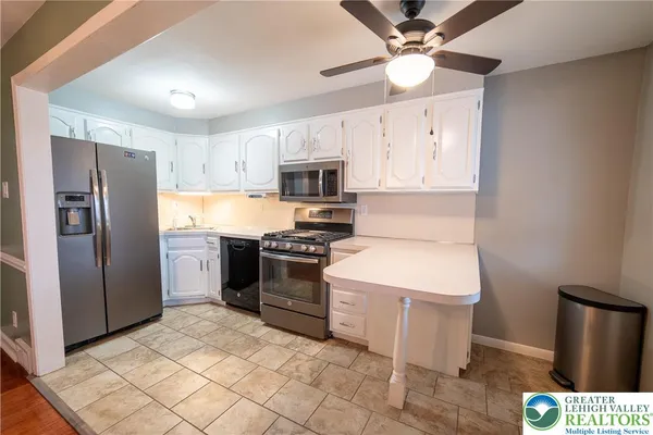 a view of a kitchen with a sink oven window and wooden floor