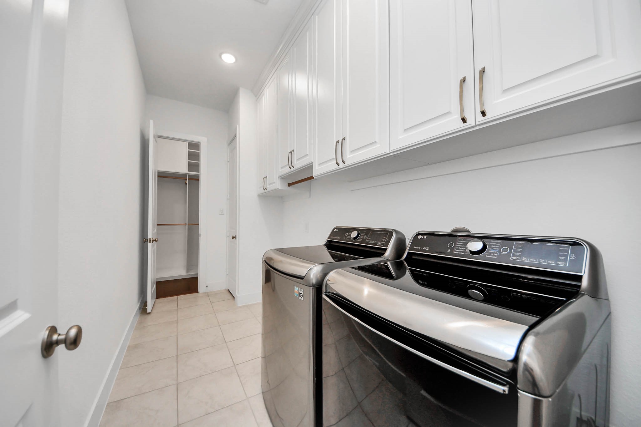 4310 Bakers Cove Manvel, TX 77578 - Photo 31 of 47 Large laundry room with custom storage and room for another appliance, connects to the primary closet and the hallway