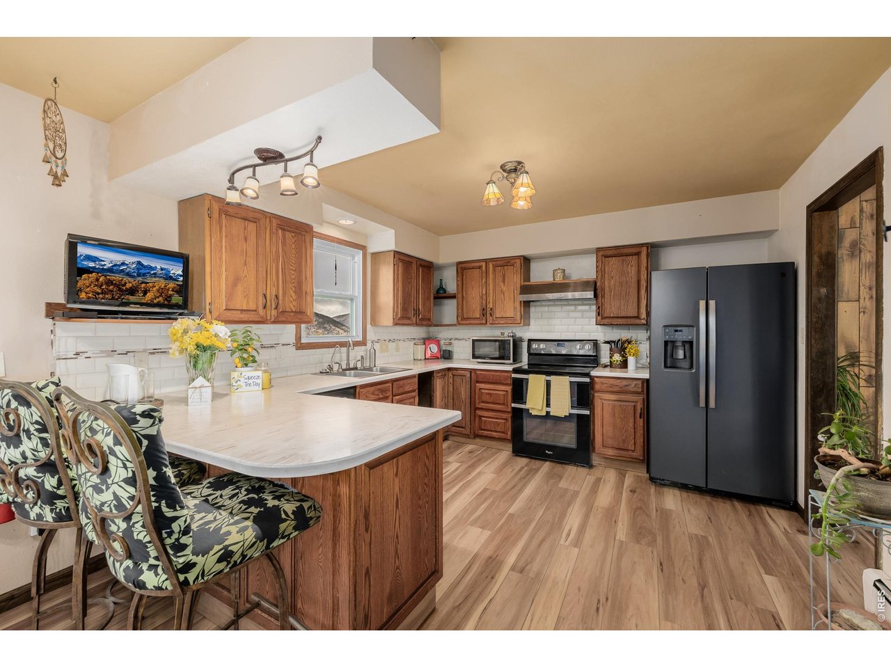 37 High View Lane Boulder, CO 80302 - Photo 17 of 50 a kitchen with stainless steel appliances kitchen island granite countertop a refrigerator a stove a sink dishwasher and a dining table with wooden floor