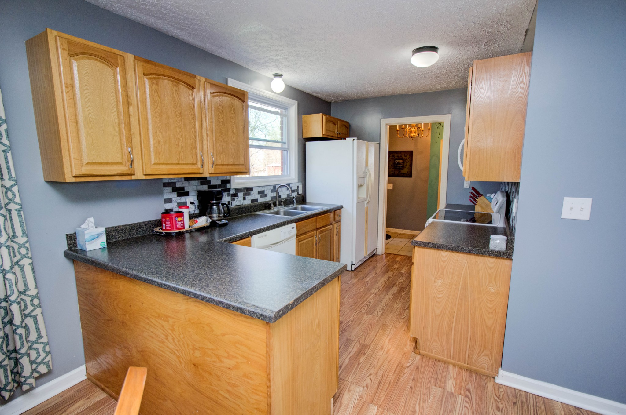 1409 5th Avenue West Springfield, TN 37172 - Photo 14 of 41 a kitchen with sink a refrigerator and cabinets