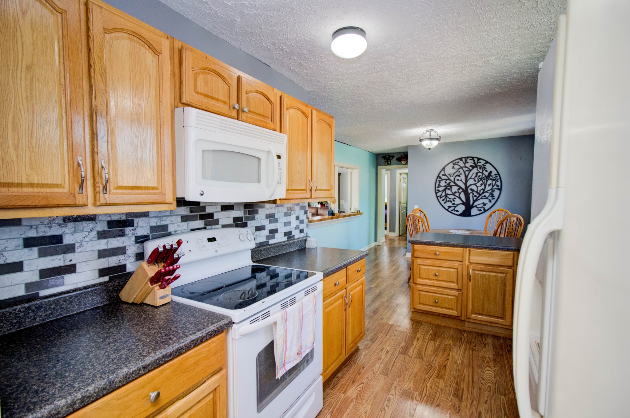 1409 5th Avenue West Springfield, TN 37172 - Photo 16 of 41 a kitchen with stainless steel appliances granite countertop a stove a sink and a microwave