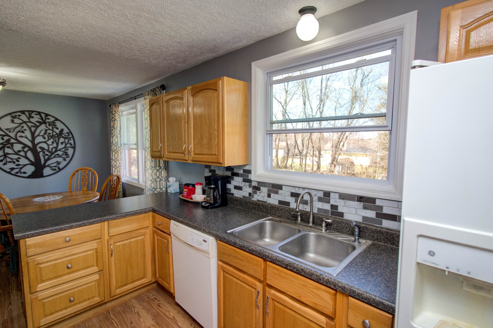 1409 5th Avenue West Springfield, TN 37172 - Photo 17 of 41 a kitchen with granite countertop a sink cabinets and window